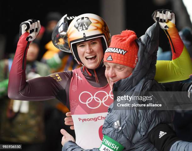 Germany's Natalie Geisenberger celebrates her victory with her coach Norbert Loch at the women's luge singles in the Alpensia Sliding Centre in...
