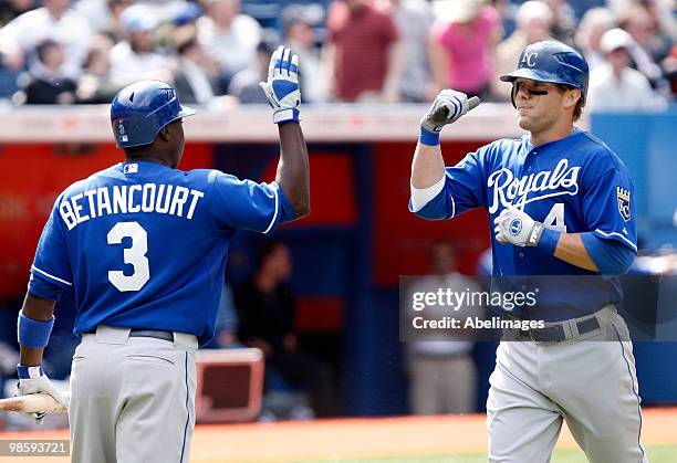 Alex Gordon of the Kansas City Royals celebrates his 10th inning home run with Yuniesky Betancourt during a MLB game against the Toronto Blue Jays at...