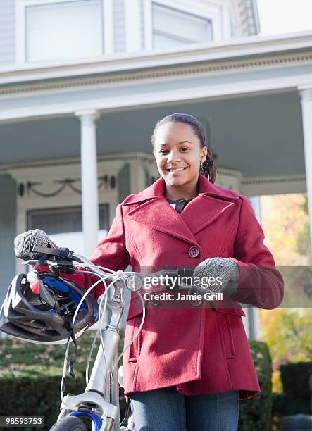 young girl with bike and helmet, smiling - montclair stock-fotos und bilder