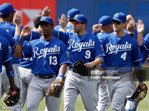 Alberto Callaspo, David DeJesus, and Alex Gordon of the Kansas City Royals celebrate the win against the Toronto Blue Jays during an MLB game at the...