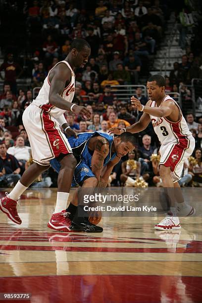 Jameer Nelson of the Orlando Magic protects the ball from defenders J.J. Hickson and Sebastian Telfair of the Cleveland Cavaliers during the game on...