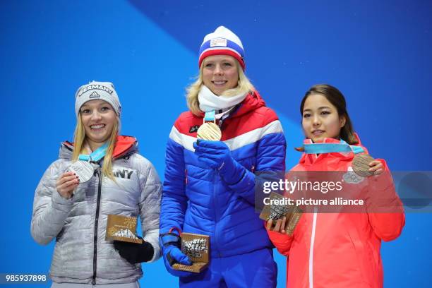 Dpatop - German silver medallist Katharina Althaus Norwegian gold medallist Maren Lundby and Japanese bronze medallist Sara Takanashi celebrate on...