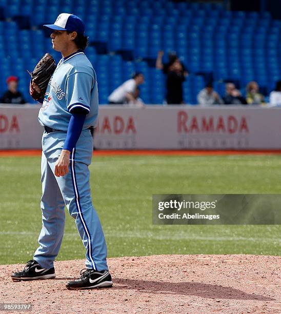 Scott Downs of the Toronto Blue Jays reacts to a home run by Alex Gordon of the Kansas City Royals in the 10th inning during an MLB game at the...