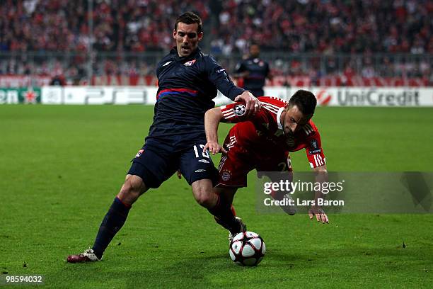 Diego Contento of Bayern is challenged by Anthony Reveillere of Lyon during the UEFA Champions League semi final first leg match between FC Bayern...