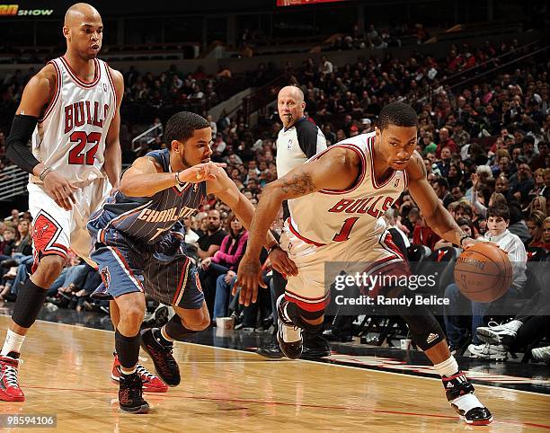 Derrick Rose of the Chicago Bulls dribble drives baseline against D.J. Augustin of the Charlotte Bobcats during the game at United Center on April 3,...