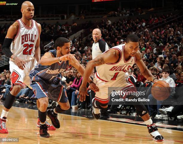 Derrick Rose of the Chicago Bulls dribble drives baseline against D.J. Augustin of the Charlotte Bobcats during the game at United Center on April 3,...