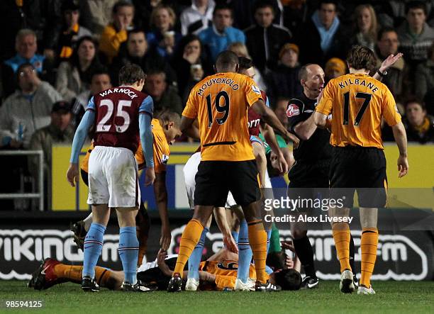 Jan Vennegoor of Hesselink of Hull City lies injured as other players look on during the Barclays Premier League match between Hull City and Aston...