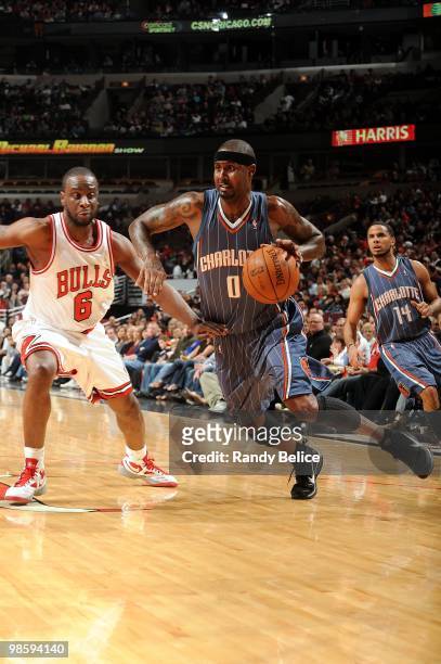 Larry Hughes of the Charlotte Bobcats dribble drives to the basket against Ronald Murray of the Chicago Bulls during the game at United Center on...