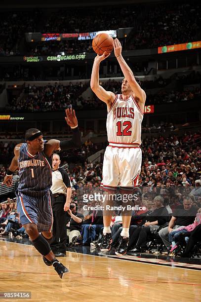 Kirk Hinrich of the Chicago Bulls shoots the outside jump shot against Stephen Jackson of the Charlotte Bobcats during the game at United Center on...