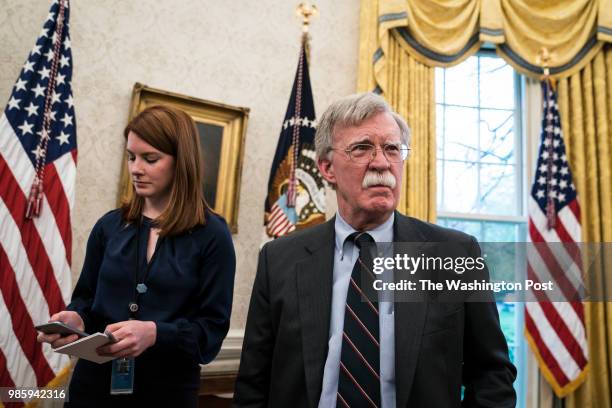 Cari Lutkins, left, and national security advisor John Bolton listen as President Donald J. Trump speaks during a meeting with Chancellor Merkel of...