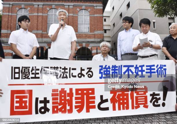 Plaintiff Kazumi Watanabe speaks in front of the Kumamoto District Court in southwestern Japan on June 28 before filing a damages suit against the...