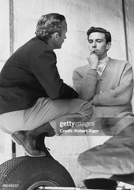 Jim Clark speaks with Lotus team owner Colin Chapman during practice before the 1965 German Grand Prix at Nuerburgring race track in July 1965 in...