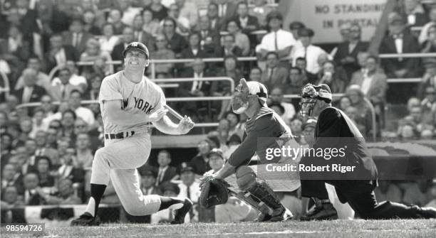 Mickey Mantle of the New York Yankees grimaces as he swings during a 1961 World Series game against the Cincinnati Reds at Crosley Field in...