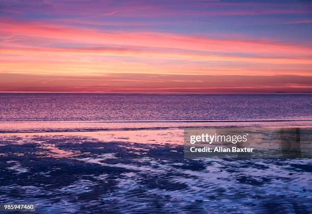 the bristol channel illuminated at sunset - ilfracombe stock pictures, royalty-free photos & images