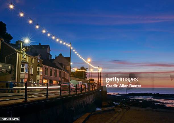 view of combe martin fishing village and sunset in north devon - ilfracombe stock pictures, royalty-free photos & images