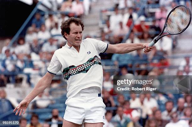 John McEnroe hits a backhand, circa 1980s.