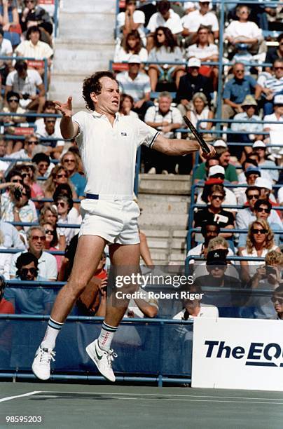 John McEnroe hits a backhand, circa 1980s.