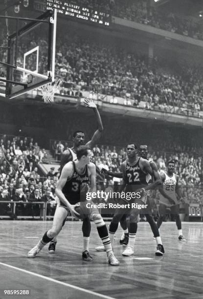 Jim Krebs of the Los Angeles Lakers posts up against Bill Russell of the Boston Celtics as Elgin Baylor looks on during Game One of the 1962 NBA...