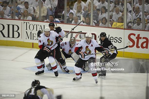Ottawa Senators goalie Brian Elliott , Anton Volchenkov , and Chris Phillips in action vs Pittsburgh Penguins Bill Guerin and Sidney Crosby . Game 1....