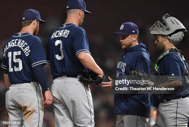 Manager Andy Green of the San Diego Padres takes the ball from starting pitcher Clayton Richard taking Richard out of the game against the San...