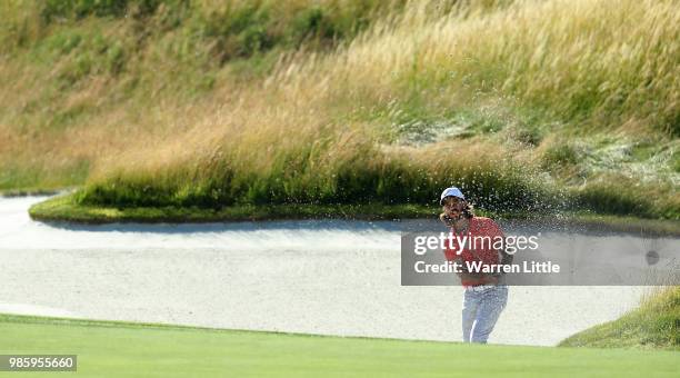 Tommy Fleetwood of England plays from a bunker on the 15th hole during the first round of the HNA Open de France at Le Golf National on June 28, 2018...