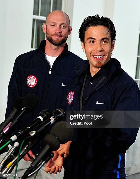 Apolo Anton Ohno, Olympic Short Track Speed Skater, right, makes remarks to reporters as Heath Calhoun, Paralympic Sit Skiier, left, looks on, after...