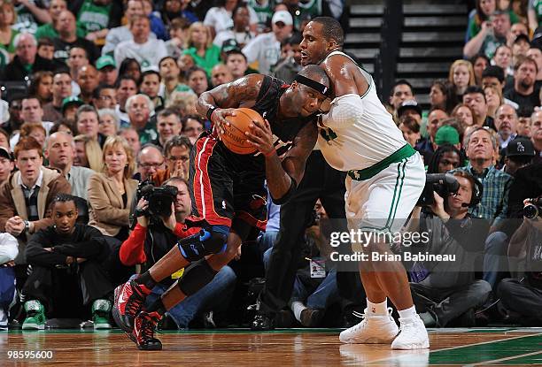 Jermaine O'Neal of the Miami Heat drives against Glen Davis of the Boston Celtics in Game One of the Eastern Conference Quarterfinals during the 2010...