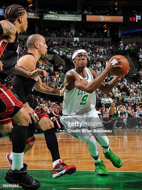 Rajon Rondo of the Boston Celtics drives against Carlos Arroyo and Michael Beasley of the Miami Heat in Game One of the Eastern Conference...