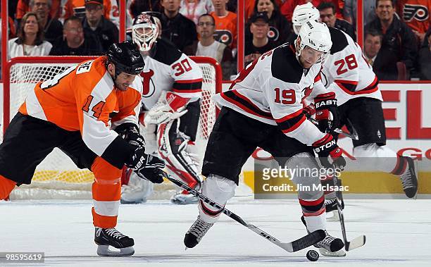 Travis Zajac of the New Jersey Devils skates against Ian Laperriere of the Philadelphia Flyers in Game Four of the Eastern Conference Quarterfinals...