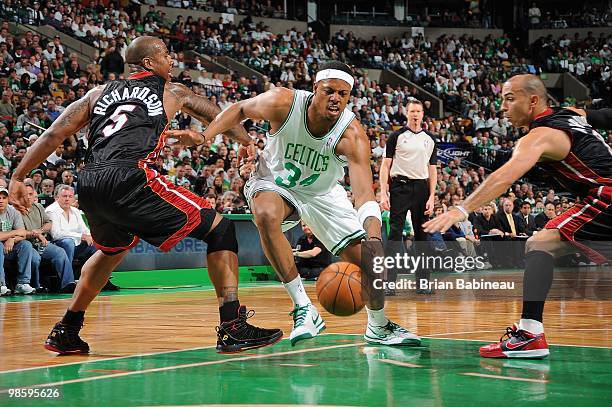 Paul Pierce of the Boston Celtics drives in between Quentin Richardson and Carlos Arroyo of the Miami Heat in Game One of the Eastern Conference...