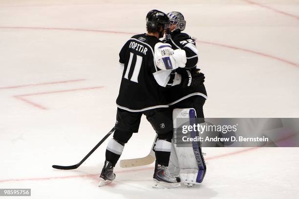 Anze Kopitar of the Los Angeles Kings celebrates with teammate Jonathan Quick after defeating the Vancouver Canucks in Game Three of the Western...