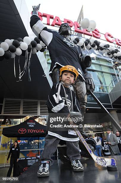 Fan of the Los Angeles Kings stands next to a statue of Wayne Gretzky prior to the Kings taking on the Vancouver Canucks in Game Three of the Western...