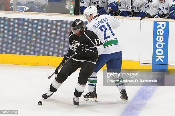 Wayne Simmonds of the Los Angeles Kings battles for the puck against Mason Raymond of the Vancouver Canucks in Game Three of the Western Conference...