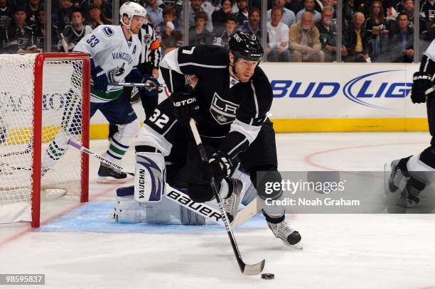 Rob Scuderi of the Los Angeles Kings skates with the puck against the Vancouver Canucks in Game Three of the Western Conference Quarterfinals during...