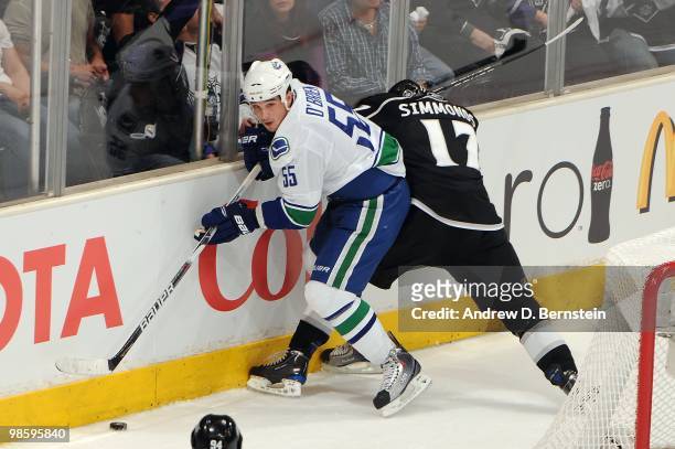 Shane O'Brien of the Vancouver Canucks battles for the puck against Wayne Simmonds of the Los Angeles Kings in Game Three of the Western Conference...