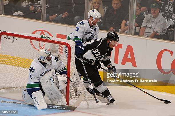 Fredrik Modin of the Los Angeles Kings skates with the puck against Henrik Sedin and Roberto Luongo of the Vancouver Canucks in Game Three of the...