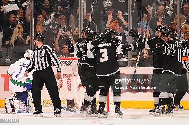 Drew Doughty, Jack Johsnon and Anze Kopitar of the Los Angeles Kings celebrate after a goal against Roberto Luongo of the Vancouver Canucks in Game...