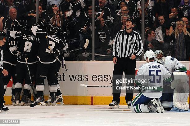 Anze Kopitar, Drew Doughty and Jack Johnson of the Los Angeles Kings celebrate after a goal against Shane O'Brien and Roberto Luongo of the Vancouver...