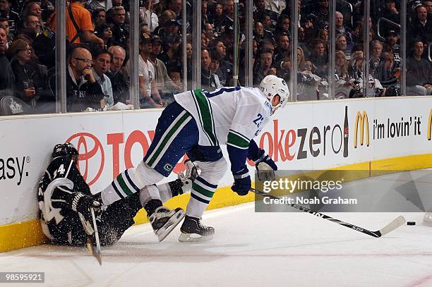 Ryan Smyth of the Los Angeles Kings gets checked into the boards by Alexander Edler of the Vancouver Canucks in Game Three of the Western Conference...