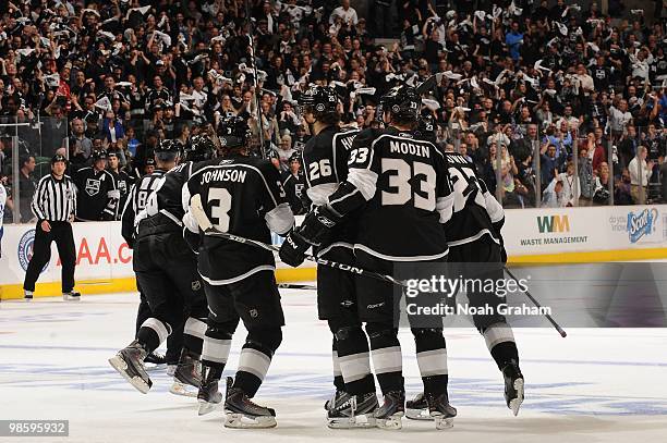 Jack Johnson, Michal Handzus, Fredrik Modin and Dustin Brown of the Los Angeles Kings skate off the ice after a goal against the Vancouver Canucks in...