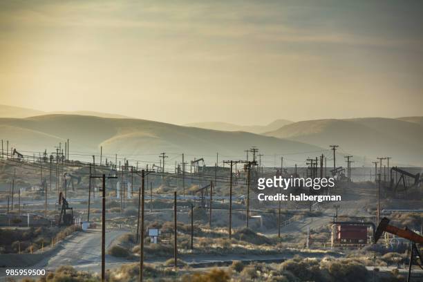 hazy sunset in kern river oil field - kern river oil field stock pictures, royalty-free photos & images