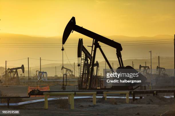 yellow sunset in kern river oil field - kern river oil field stock pictures, royalty-free photos & images