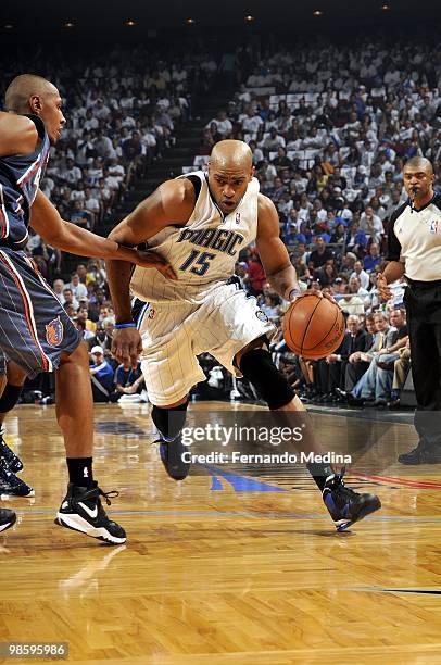 Vince Carter of the Orlando Magic drives the ball up court against Boris Diaw of the Charlotte Bobcats in Game One of the Eastern Conference...