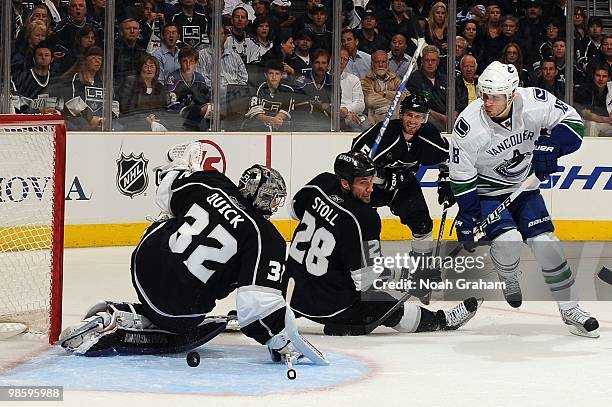 Jonathan Quick of the Los Angeles Kings reaches to make the save while teammate Jarret Stoll tries to stop Steve Bernier of the Vancouver Canucks in...