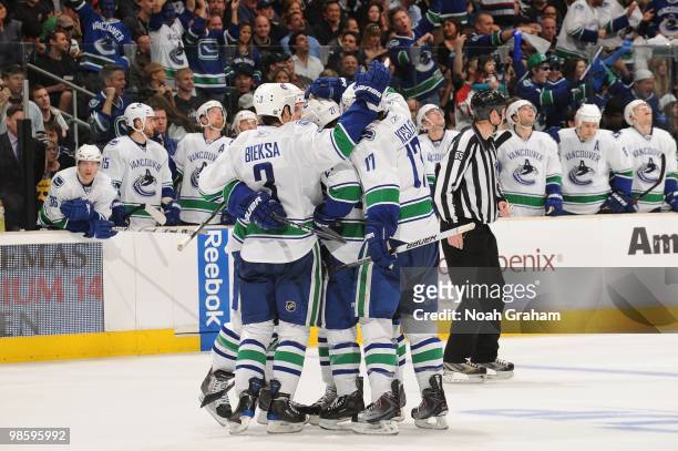 Kevin Bieksa and Ryan Kesler of the Vancouver Canucks celebrate with teammates after a goal against the Los Angeles Kings in Game Three of the...