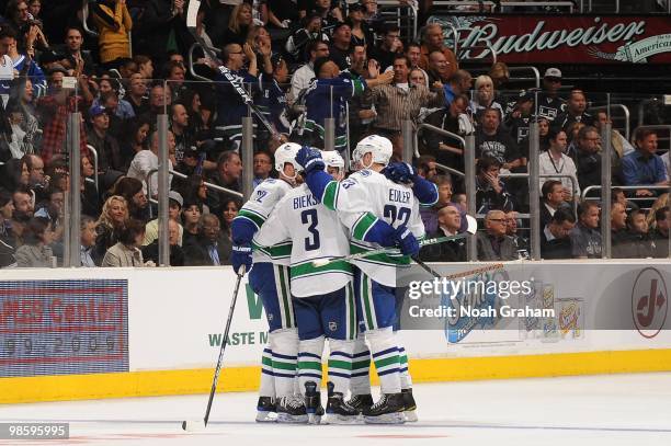 Kevin Bieksa and Alexander Edler of the Vancouver Canucks celebrate with teammates after a goal against the Los Angeles Kings in Game Three of the...