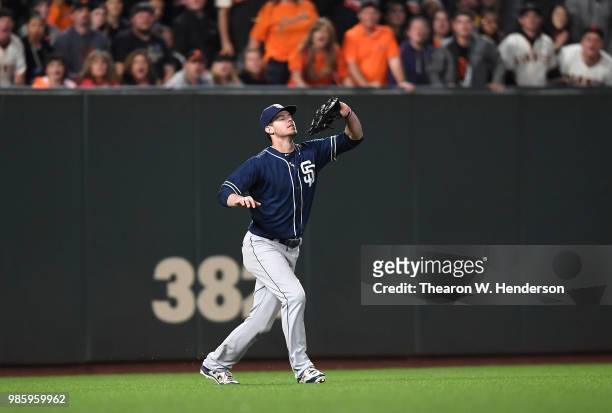 Wil Myers of the San Diego Padres catches a fly ball off the bat of Alen Hanson of the San Francisco Giants in the bottom of the seventh inning at...