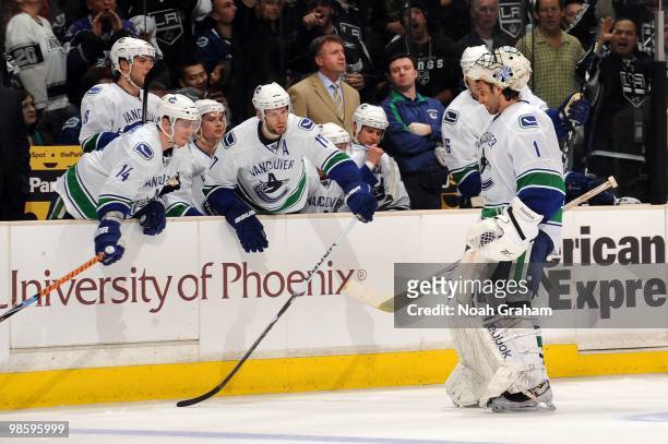 Roberto Luongo of the Vancouver Canucks skates to the bench after being pulled in the second period against the Los Angeles Kings in Game Three of...