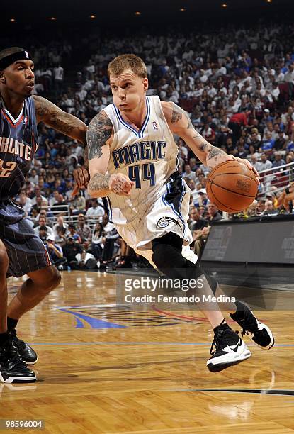 Jason Williams of the Orlando Magic drives to the basket against Tyrus Thomas of the Charlotte Bobcats in Game One of the Eastern Conference...