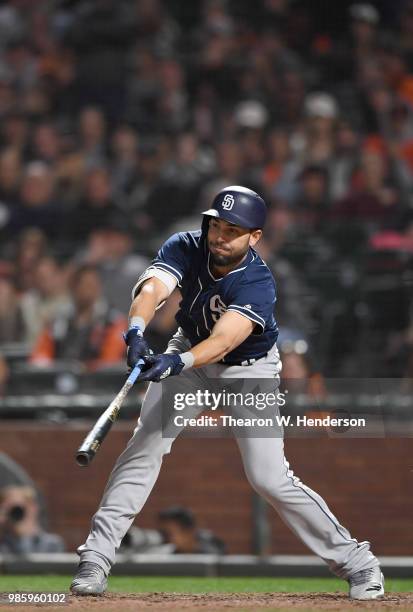 Eric Hosmer of the San Diego Padres hits a bases loaded two-run rbi single against the San Francisco Giants in the top of the ninth inning at AT&T...